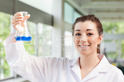 Cute science student holding an Erlemeyer flask