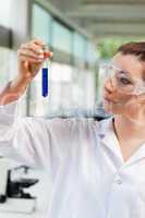 Portrait of a female science student looking at a test tube