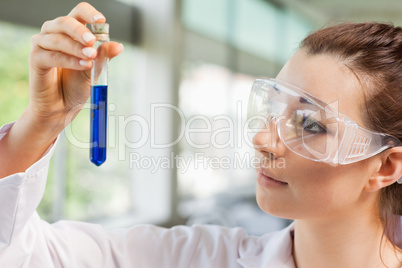 Female science student looking at a test tube