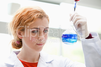Science student looking at a mixed liquid