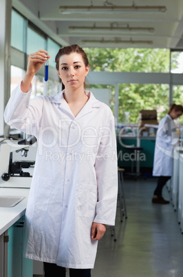Portrait of a beautiful scientist holding a test tube