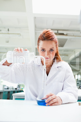 Portrait of a cute science student doing an experiment