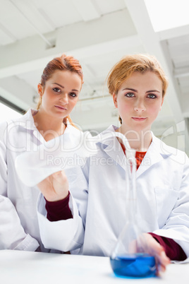 Portrait of cute science students doing an experiment