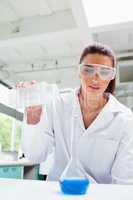 Portrait of a female science student pouring liquid