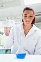 Portrait of a female scientist pouring liquid