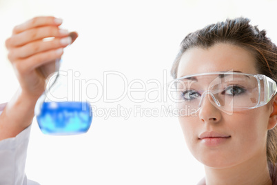 Close up of a scientist holding a flask