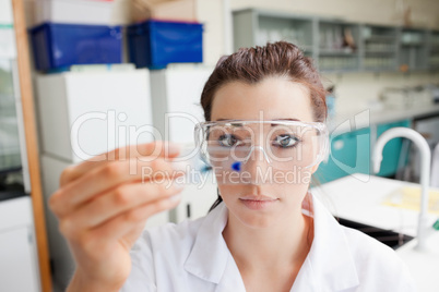 Cute science student looking at a microscope slide
