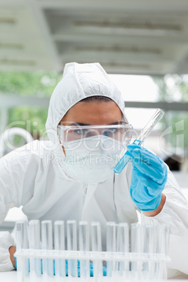 Portrait of a protected female scientist holding a test tube