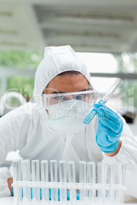 Portrait of a protected serious scientist holding a test tube