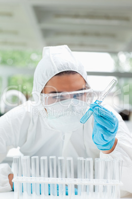 Portrait of a protected science student looking at a test tube