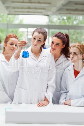Portrait of science students looking at a flask