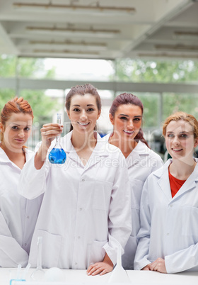 Portrait of lab partners posing with a flask
