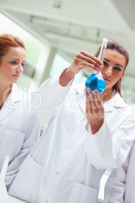 Portrait of scientists looking a flask