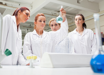 Chemistry students looking at a liquid