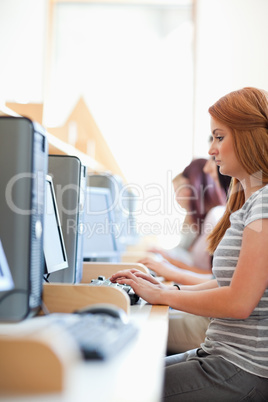 Portrait of a serious student working with a computer