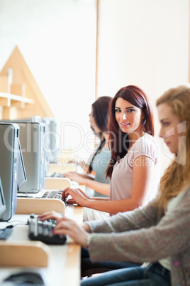 Portrait of a smiling student with a computer