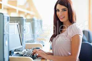 Brunette student posing with a computer
