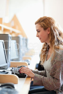 Portrait of a cute student working with a computer