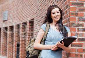 Student posing with a binder