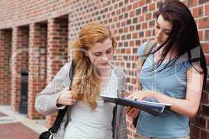 Student showing something to her classmate