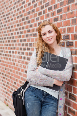 Portrait of a lovely student holding her binder