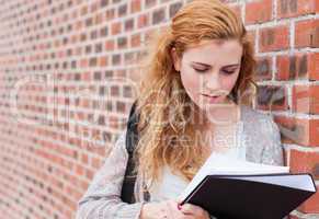 Lovely student reading her notes