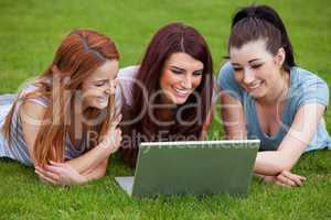 Smiling women using a notebook