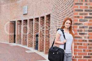 Smiling student posing with a bag