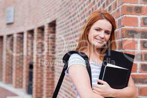 Smiling student holding her binder