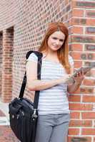 Portrait of a serious student holding a tablet computer