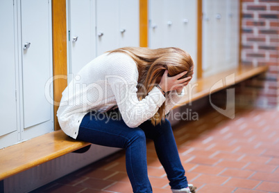 Depressed student sitting on a bench