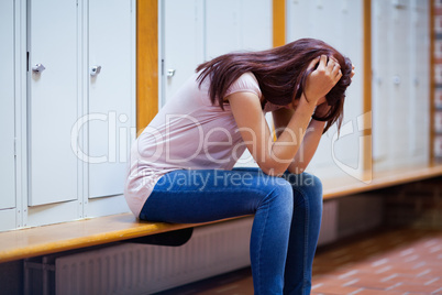 Sad student sitting on a bench