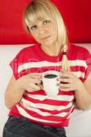 Attractive young woman drinking coffee at home