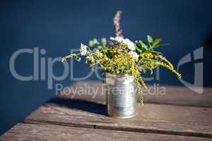 wildflowers in a tin on the table
