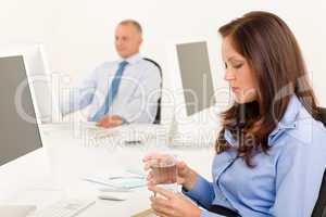 Businesswoman sit in office hold water glass
