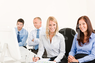 Business team happy sit in line behind table