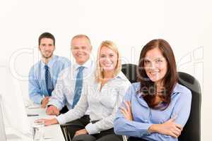 Business team happy sit in line behind table