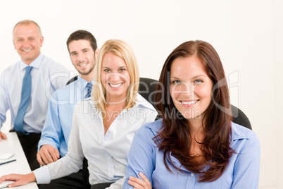 Business team happy sit in line behind table