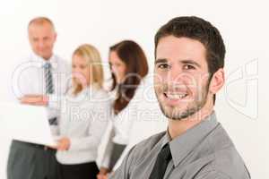 Businessman handsome with colleagues in the back