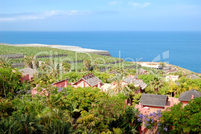 Recreation area with villas of luxury hotel and banana's plantat