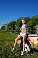 young sexy woman stay near retro car