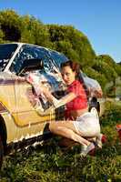 Attractive pinup girl washing a car at summer