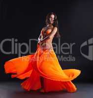 beauty dancer posing in traditional orange costume