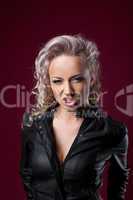 Pretty sexy anger blond woman in leather jacket