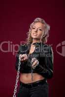 Anger woman in sexy leather jacket with chain