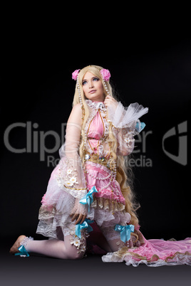 Attractive girl posing in fairy-tale doll costume