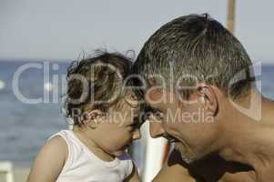 Father and Daughter looking each other on the Beach