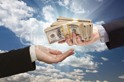 Handing Over Cash with Dramatic Clouds and Sky