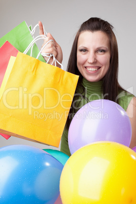 Young  woman with balloons and bags