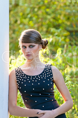 Caucasian girl with opened eyes in black dress